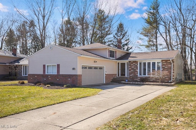 view of front of property featuring brick siding, a chimney, a garage, and a front yard