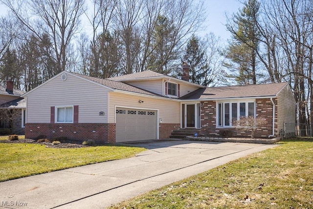 view of front of home with brick siding, a chimney, a garage, and a front yard