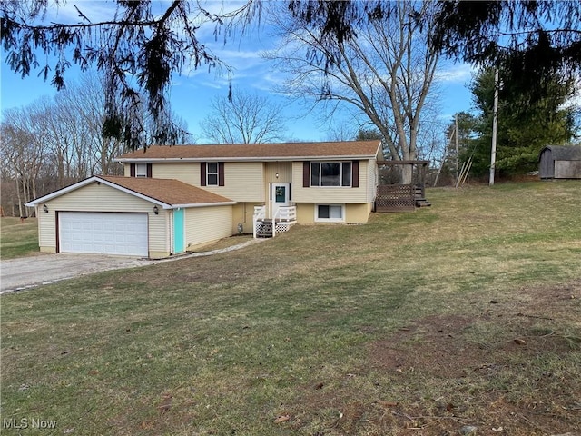 bi-level home with an attached garage, a shed, a front yard, an outbuilding, and driveway