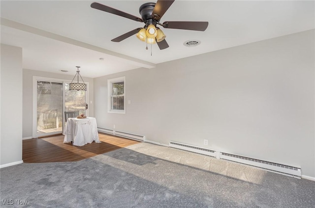 carpeted spare room with baseboards, visible vents, and baseboard heating