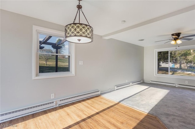 empty room with a baseboard radiator and plenty of natural light