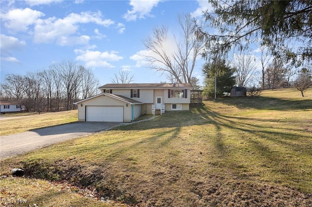 bi-level home with a garage, a front yard, and driveway