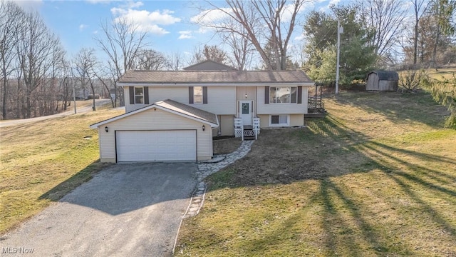 split foyer home featuring an outbuilding, driveway, a storage shed, and a front lawn