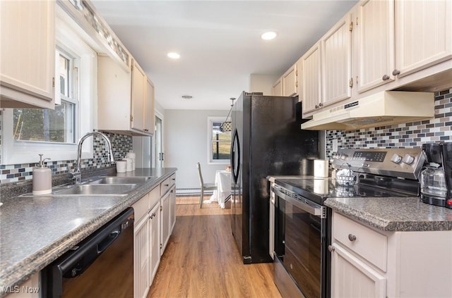 kitchen featuring light wood finished floors, a sink, electric stove, under cabinet range hood, and dishwasher