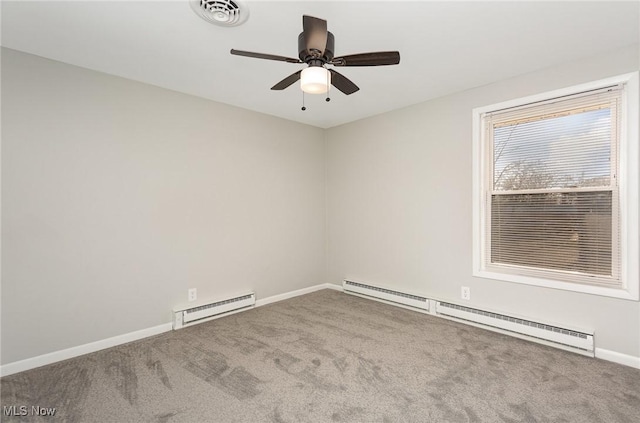 carpeted spare room with visible vents, baseboards, ceiling fan, and a baseboard radiator