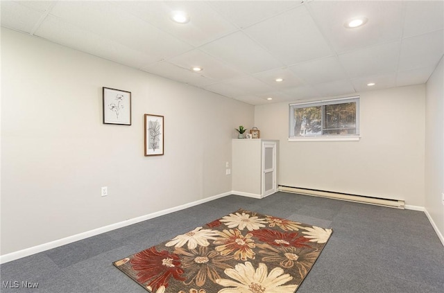 interior space with baseboards, recessed lighting, a drop ceiling, dark colored carpet, and baseboard heating