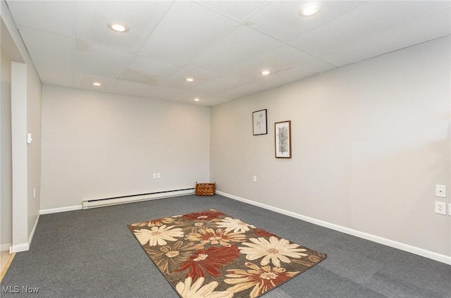 basement featuring recessed lighting, baseboards, a baseboard heating unit, and carpet