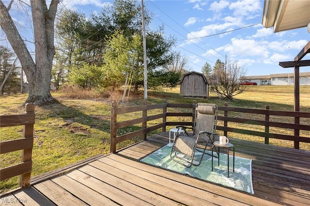 wooden terrace with a yard, an outbuilding, and a storage shed