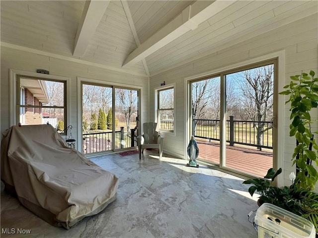 unfurnished sunroom featuring lofted ceiling with beams and wooden ceiling