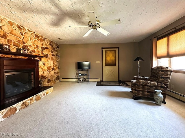 unfurnished room featuring a ceiling fan, carpet floors, a fireplace, a textured ceiling, and a baseboard heating unit