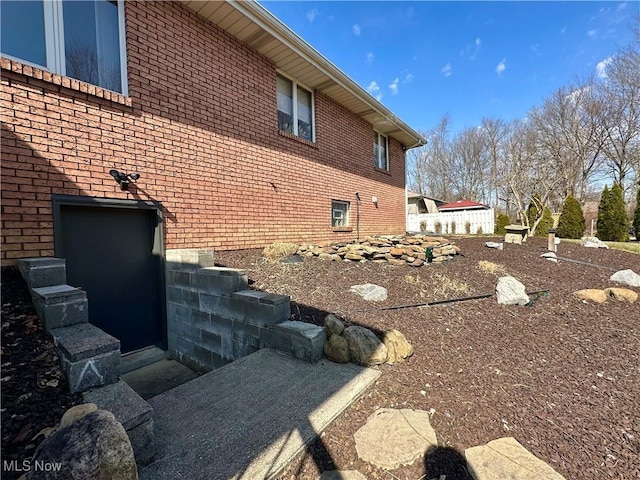 view of side of property with brick siding