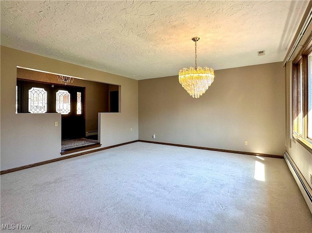 carpeted spare room featuring a baseboard heating unit, baseboards, an inviting chandelier, a textured ceiling, and a baseboard radiator