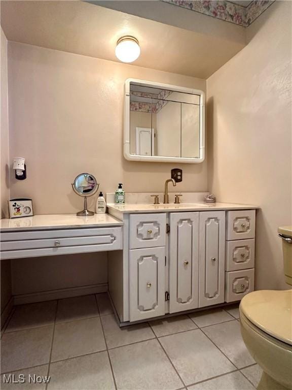 bathroom with tile patterned flooring, toilet, and vanity