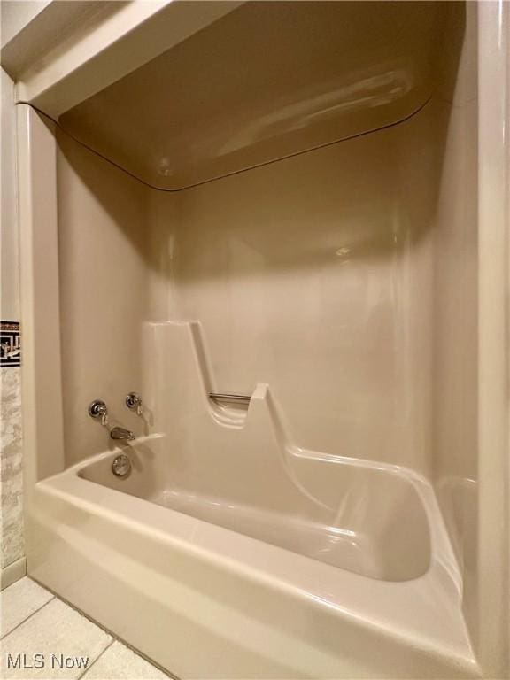 full bath with tile patterned flooring and shower / bathtub combination