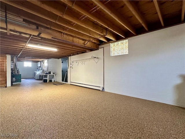 basement with baseboard heating and concrete block wall