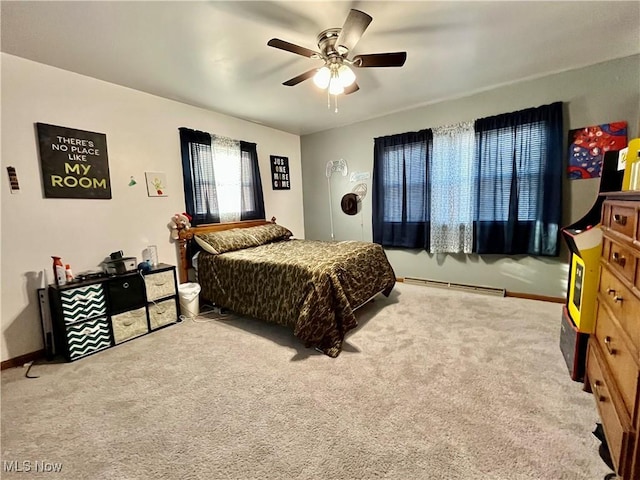 carpeted bedroom with a baseboard radiator, baseboards, and ceiling fan