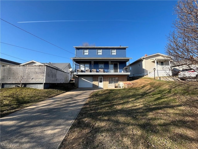 back of house with a balcony, a yard, concrete driveway, a garage, and brick siding