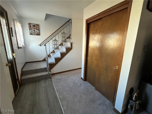 stairway featuring wood finished floors and baseboards