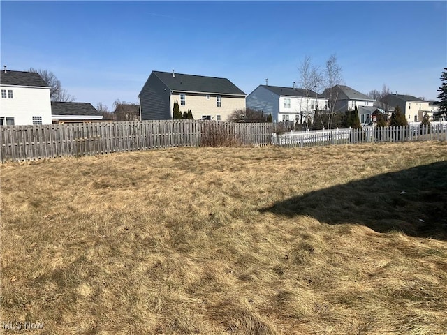 view of yard featuring a residential view and fence