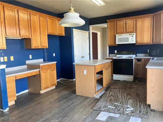 kitchen with dark wood-style floors, white microwave, electric range, hanging light fixtures, and a center island