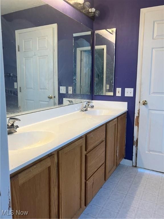 bathroom with double vanity, tile patterned floors, and a sink