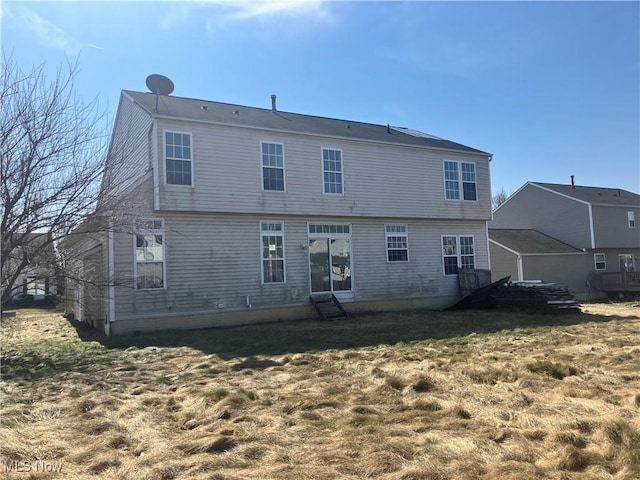 rear view of house with a lawn