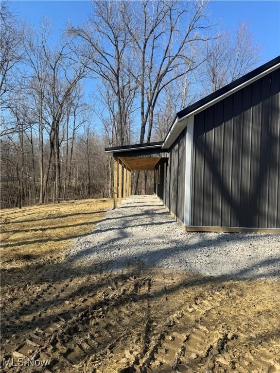 exterior space featuring gravel driveway and an attached carport