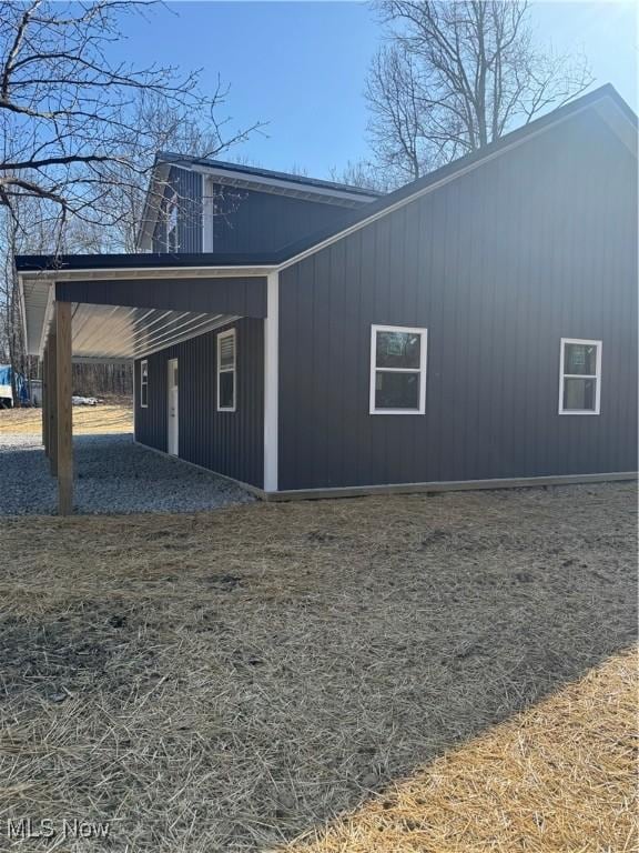 view of side of property with an attached carport