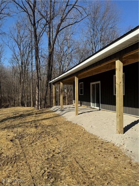 rear view of property with board and batten siding