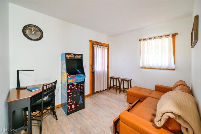 living room with baseboards and wood finished floors