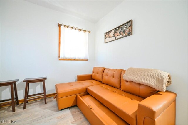 living area featuring baseboards and light wood-style floors