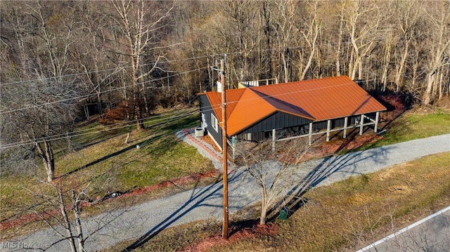 drone / aerial view with a wooded view