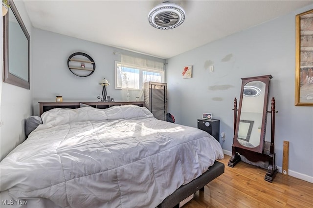 bedroom featuring baseboards and light wood-style flooring