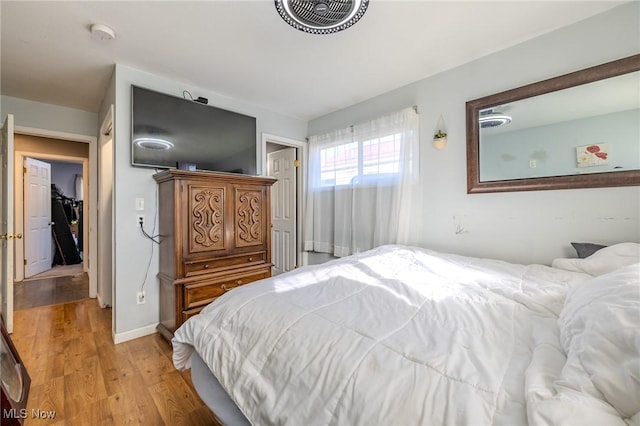 bedroom with baseboards and light wood-style floors