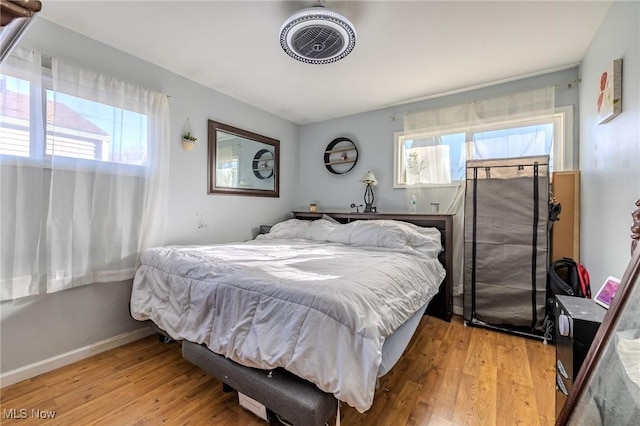 bedroom featuring light wood-style floors and baseboards