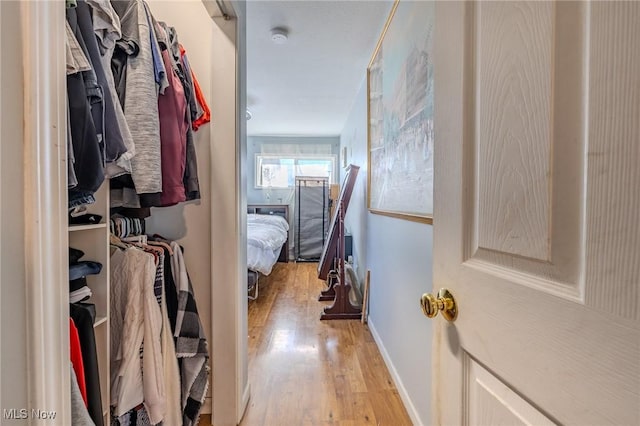 walk in closet featuring light wood-style floors