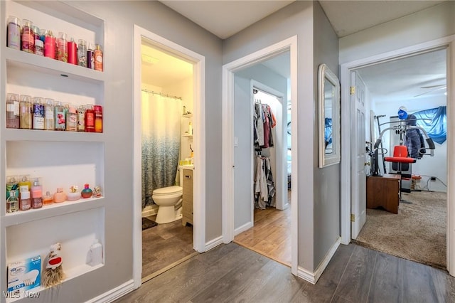 hall featuring dark wood finished floors and baseboards