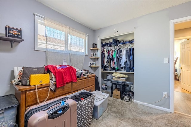 bedroom with a closet, baseboards, and carpet