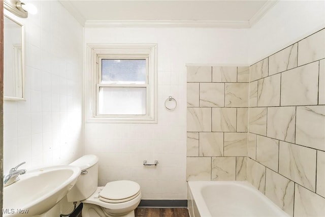 bathroom featuring a sink, toilet, tile walls, and crown molding