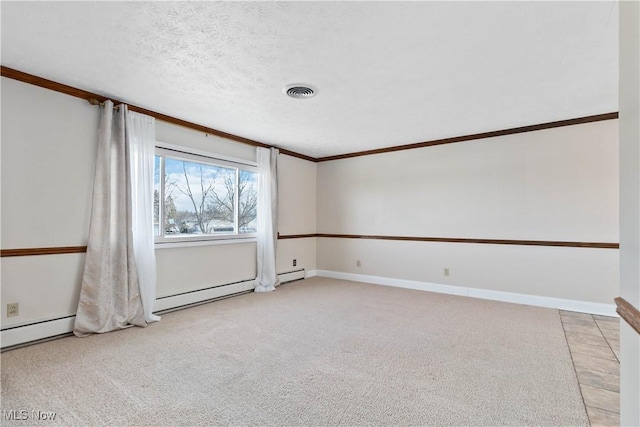 spare room featuring light colored carpet, baseboards, a textured ceiling, and visible vents