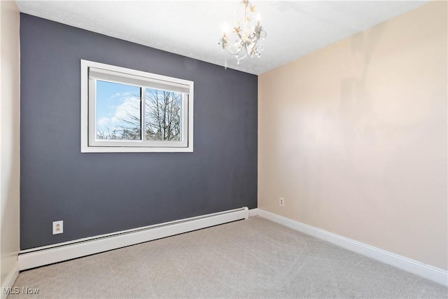 spare room with a baseboard heating unit, baseboards, carpet, and an inviting chandelier