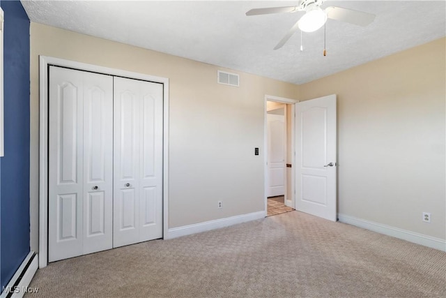 unfurnished bedroom with a closet, carpet flooring, baseboards, and visible vents