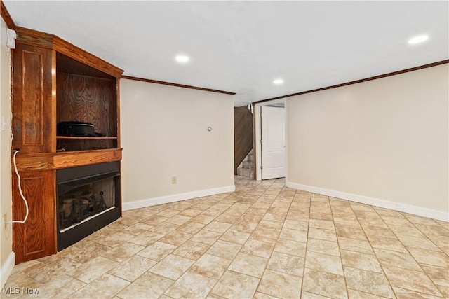 unfurnished living room featuring baseboards, a large fireplace, ornamental molding, and stairs