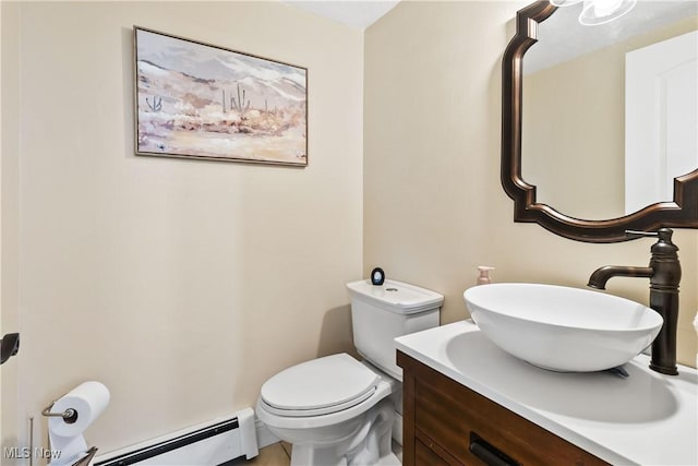 bathroom featuring a baseboard heating unit, toilet, and vanity