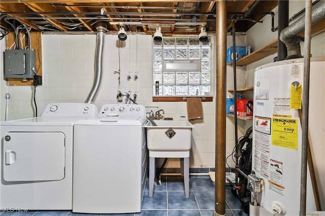 clothes washing area featuring laundry area, electric panel, separate washer and dryer, gas water heater, and tile patterned floors