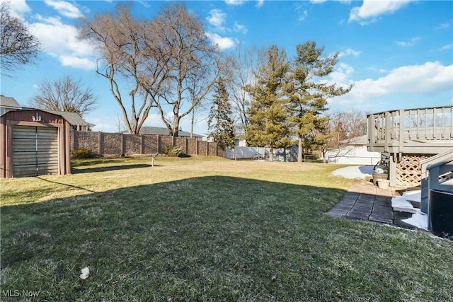 view of yard featuring a fenced backyard, a storage unit, and an outdoor structure