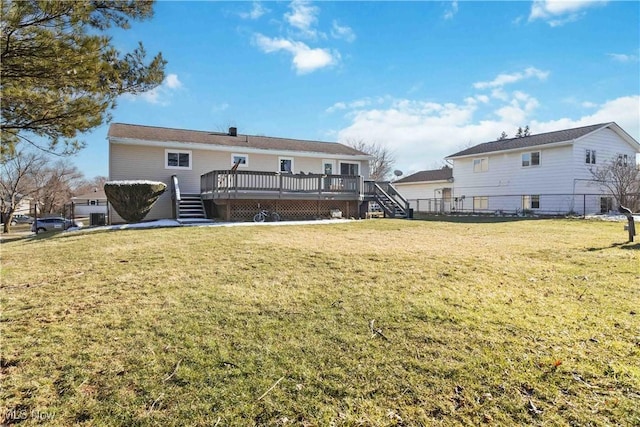 rear view of property featuring a deck, stairs, and a yard