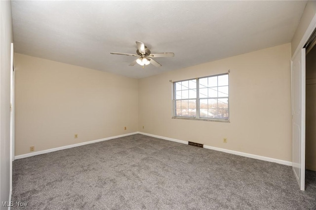 unfurnished bedroom featuring visible vents, a closet, carpet floors, baseboards, and ceiling fan