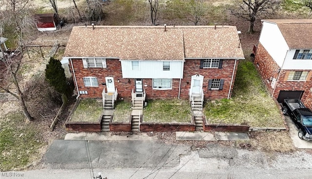 townhome / multi-family property featuring brick siding