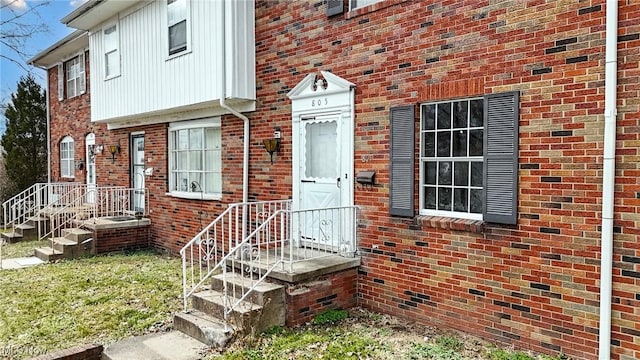 doorway to property with brick siding